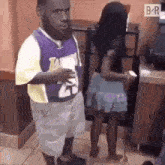 a man with a beard is standing next to a woman in a skirt in a restaurant .