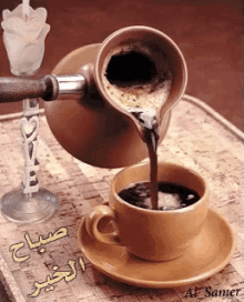 a cup of coffee is being poured from a coffee pot on a saucer
