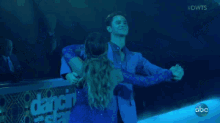 a couple is dancing in a pool with the words #dwts above them