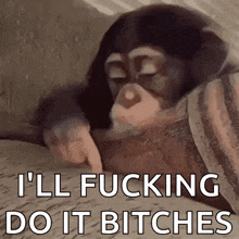 a chimpanzee is laying on a bed and pointing at something .