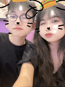 a boy and a girl are posing for a picture with a cat mask on their face