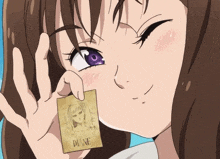 a girl with purple eyes is holding a card with diane on it