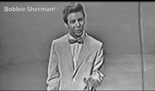 a black and white photo of a man with the name bobbie sherman