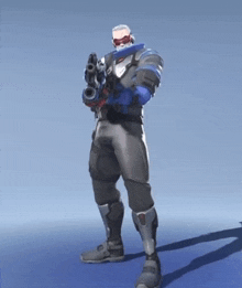 a man in a suit is holding a gun in his hand .