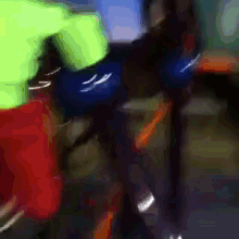 a blurry picture of a person in a green shirt and red shorts