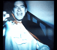 a man wearing a cape with the letter l on it is standing on a set of stairs
