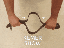 a picture of a person holding a brown belt with the words kemer show below it