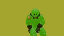 a green robot with a g on his chest