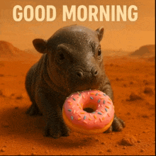 a baby hippo is eating a pink donut with sprinkles and says good morning