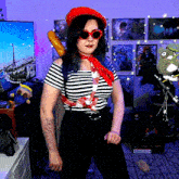 a woman wearing a red beret and sunglasses holds a french baguette