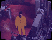 a man in a yellow suit is standing in a room with cam 001 written on it
