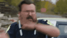 a man with a mustache is wearing a shirt that says ' i ' on it