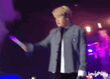 a blurry picture of a man on a stage with the words imgplay at the bottom right
