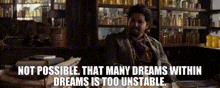 a man sitting at a desk with a quote that says not possible that many dreams within dreams is too unstable