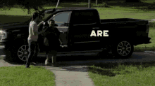 a black truck has the word are on the side