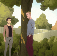 a man and a woman standing next to a tree with a fence in the background