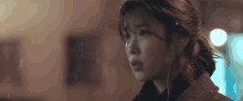 a close up of a woman 's face with snow falling on her hair
