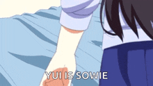 a person is holding another person 's hand with the words yui is sowie written on it .
