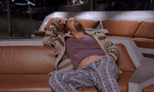 a man laying on a couch with a sweater that says zucrm on it