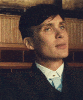 a close up of a man 's face wearing a suit