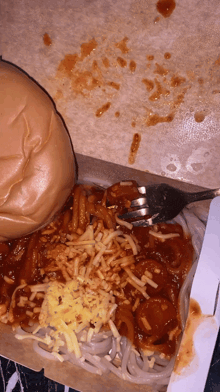 a box of spaghetti with a hamburger and a fork