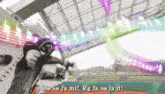 a man is holding a sword in a stadium and says do so fa mi
