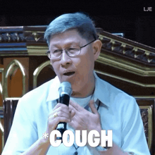 a man speaking into a microphone with the word couch written below him