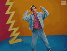 a man is standing in front of a snl logo