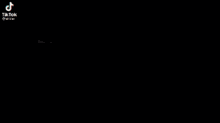 a group of men are standing in a room with a tiktok logo on the top