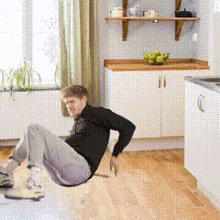 a man is doing push ups on a wooden floor