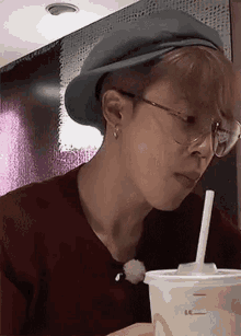 a close up of a person wearing glasses and a hat .