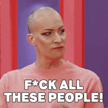 a woman with a shaved head is wearing a pink shirt that says f * ck all these people
