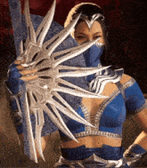 a woman in a blue costume is holding a large fan