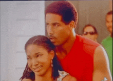 a man and a woman are standing next to each other .