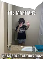 a man taking a picture of himself in a bathroom mirror with the words the martians are invading