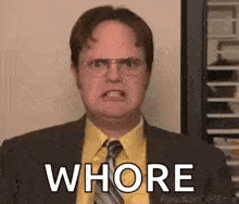 dwight schrute from the office is making a funny face and saying whore .