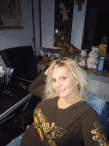 a woman wearing a brown shirt that says ed hardy on the front