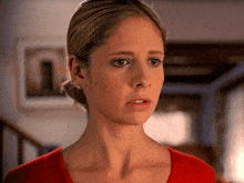 a close up of a woman 's face with a serious look on her face