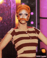a woman in a striped shirt has a fake mustache on her face and the word tumblr is on the bottom right