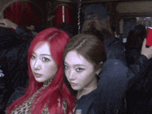 two women with red hair are posing for a picture together