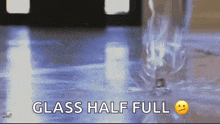 a glass half full is being poured into a glass