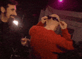 a bald man wearing sunglasses is being punched