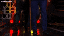 two men in suits are walking on a stage with a cane ..