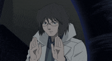 a man with glasses and a white coat is making a stop sign with his hands
