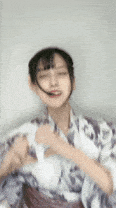 a woman in a kimono is making a funny face