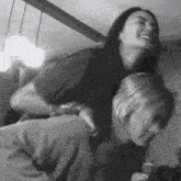 a woman is carrying another woman on her back in a black and white photo