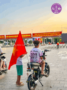 a man on a motorcycle wearing a 2011 shirt