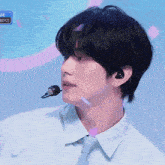 a close up of a person wearing a tie and earbuds with the word boyz in the corner