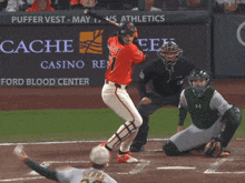 a baseball game is being played in front of an advertisement for the cache casino resort