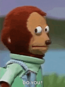 a stuffed monkey with a green shirt and blue overalls is asking do you .
